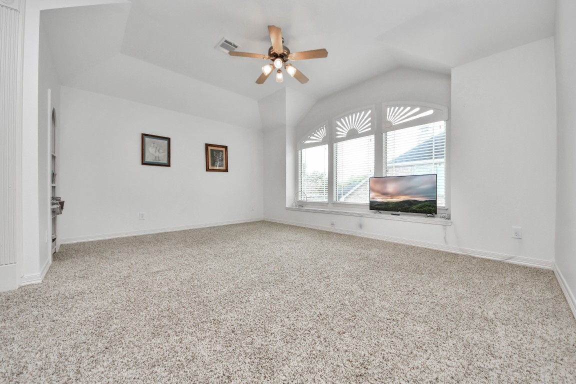 5703 Brennan Ridge Lane Katy, TX 77450 - Photo 38 of 45 an empty room with windows and ceiling fan