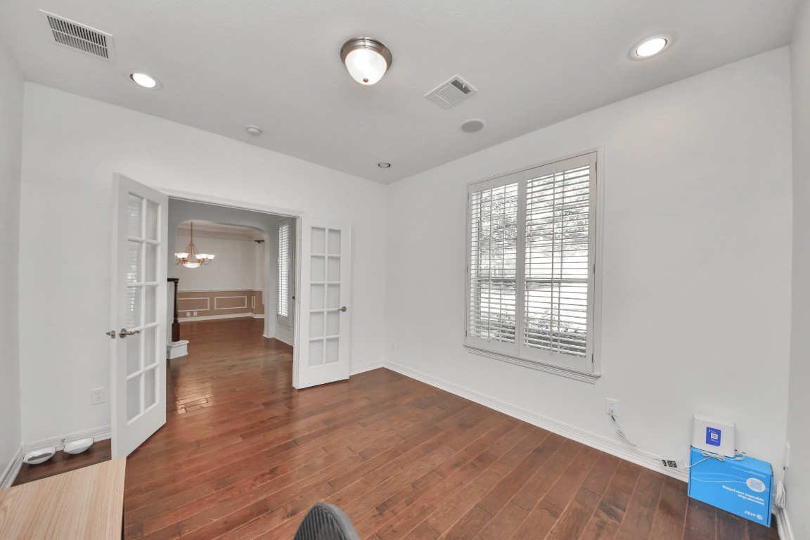 5703 Brennan Ridge Lane Katy, TX 77450 - Photo 9 of 45 wooden floor in an empty room with a window