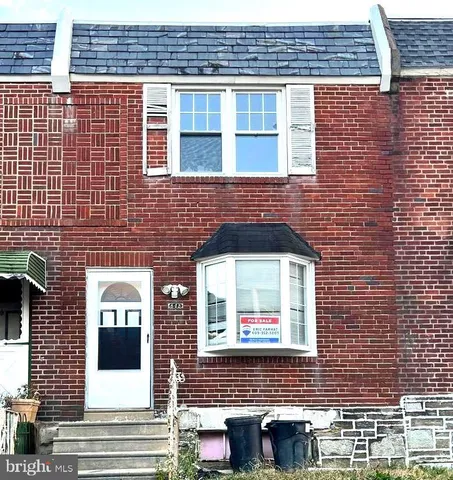 a front view of a building with a couple of windows