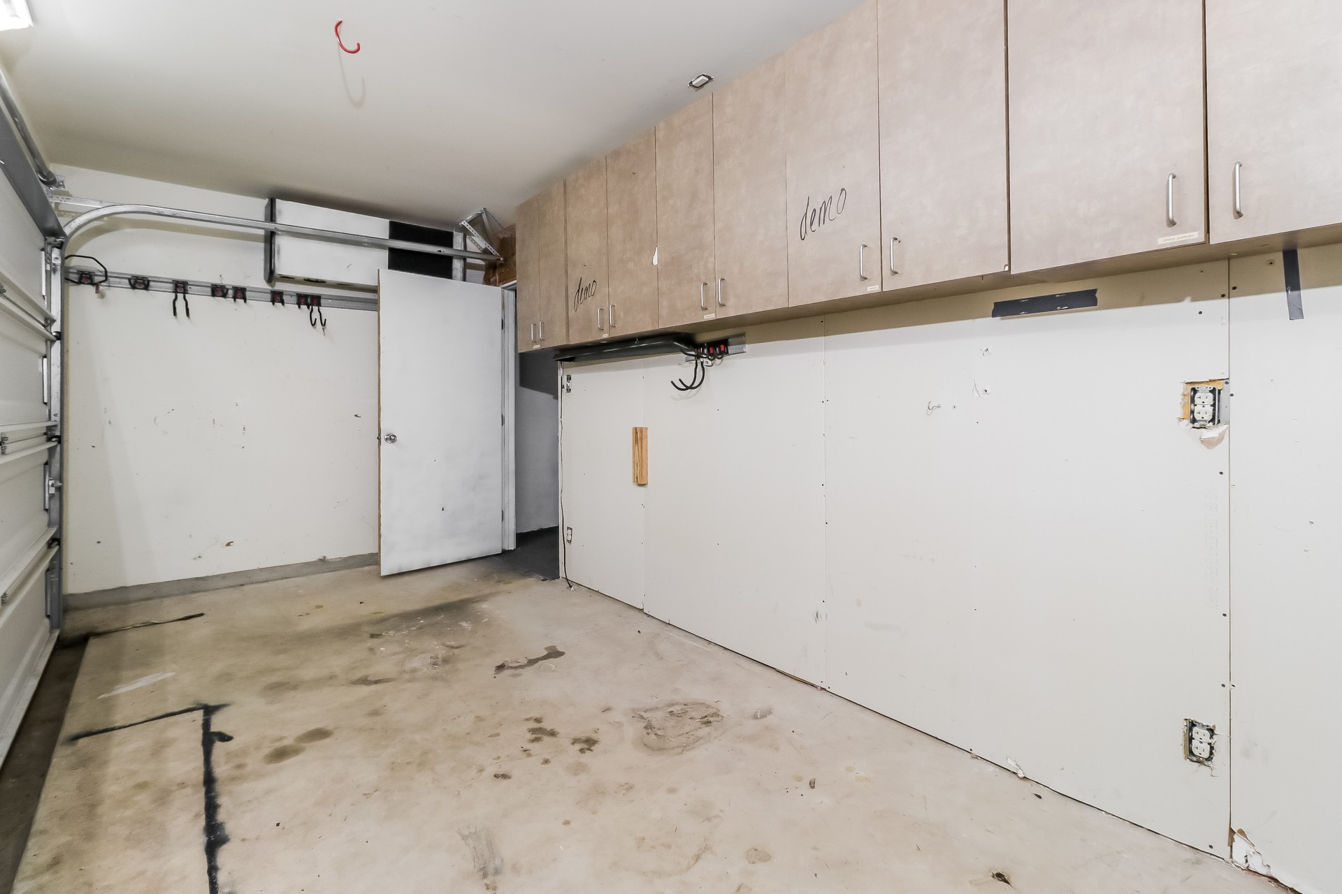 20017 Hubert R Humphrey Road Manor, TX 78653 - Photo 24 of 27 Functional garage with overhead cabinetry provides ample storage and utility space.