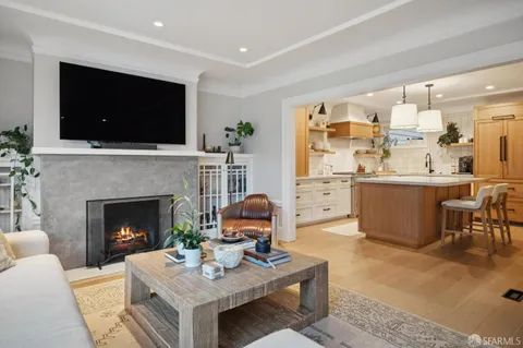 a bedroom with a bed and a flat tv screen on dresser