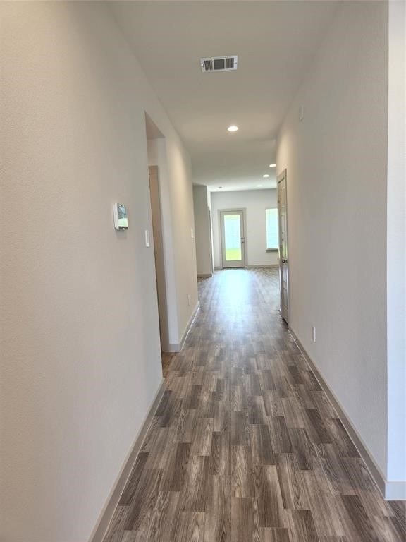 7826 Sleek Flock Lane Rosharon, TX 77583 - Photo 2 of 16 a view of a hallway with wooden floor