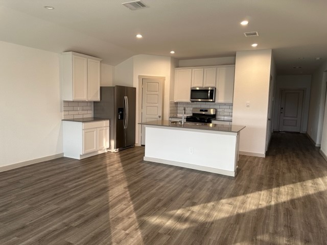 7826 Sleek Flock Lane Rosharon, TX 77583 - Photo 4 of 16 a kitchen with stainless steel appliances a refrigerator and a stove top oven