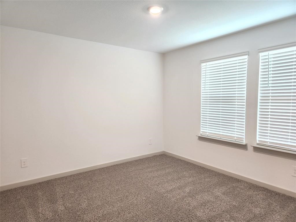 7826 Sleek Flock Lane Rosharon, TX 77583 - Photo 6 of 16 an empty room with a window