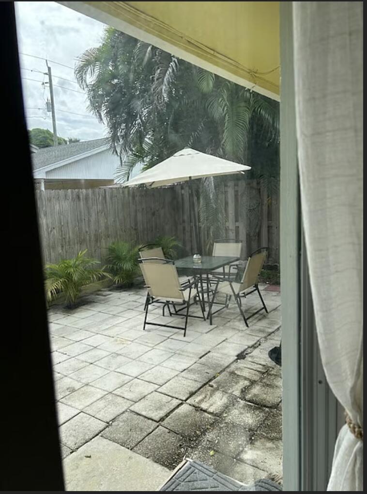 1822 Windsor Drive, Unit 1 Juno Ridge, FL 33408 - Photo 10 of 12 a outdoor view with a sitting space