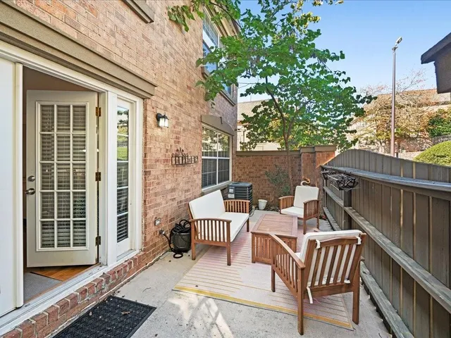 a view of a patio with a table and chairs