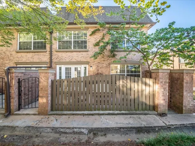 a view of a brick house with a large windows