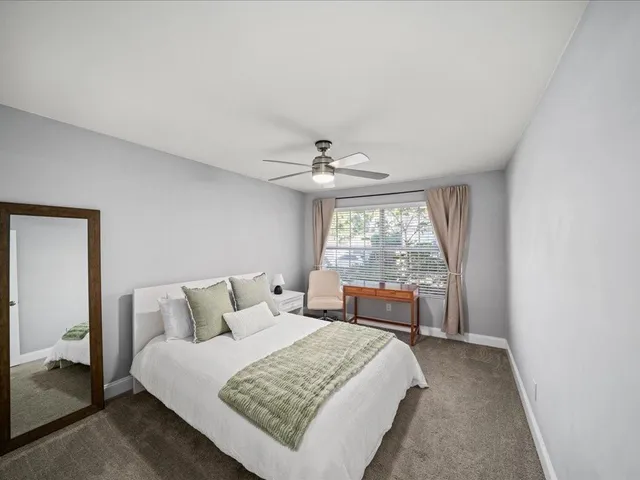 a bedroom with a large bed and a large window