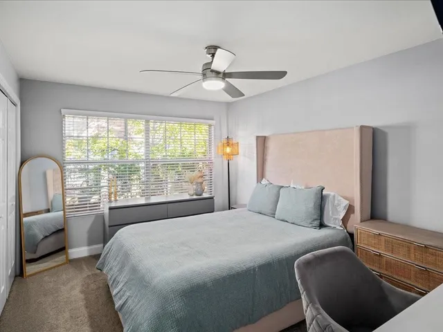 a bedroom with a large bed and a large window