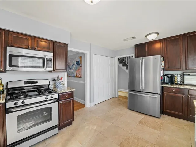 a kitchen with stainless steel appliances a refrigerator stove and microwave
