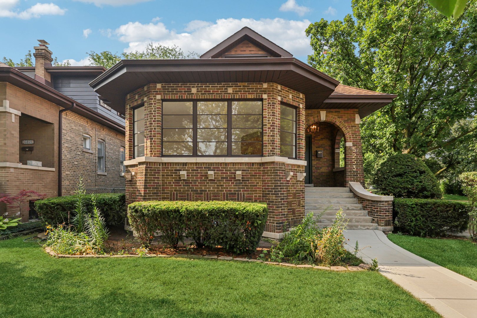 5253 Cleveland Street Skokie, IL 60077 - Photo 2 of 57 a front view of a house with a yard
