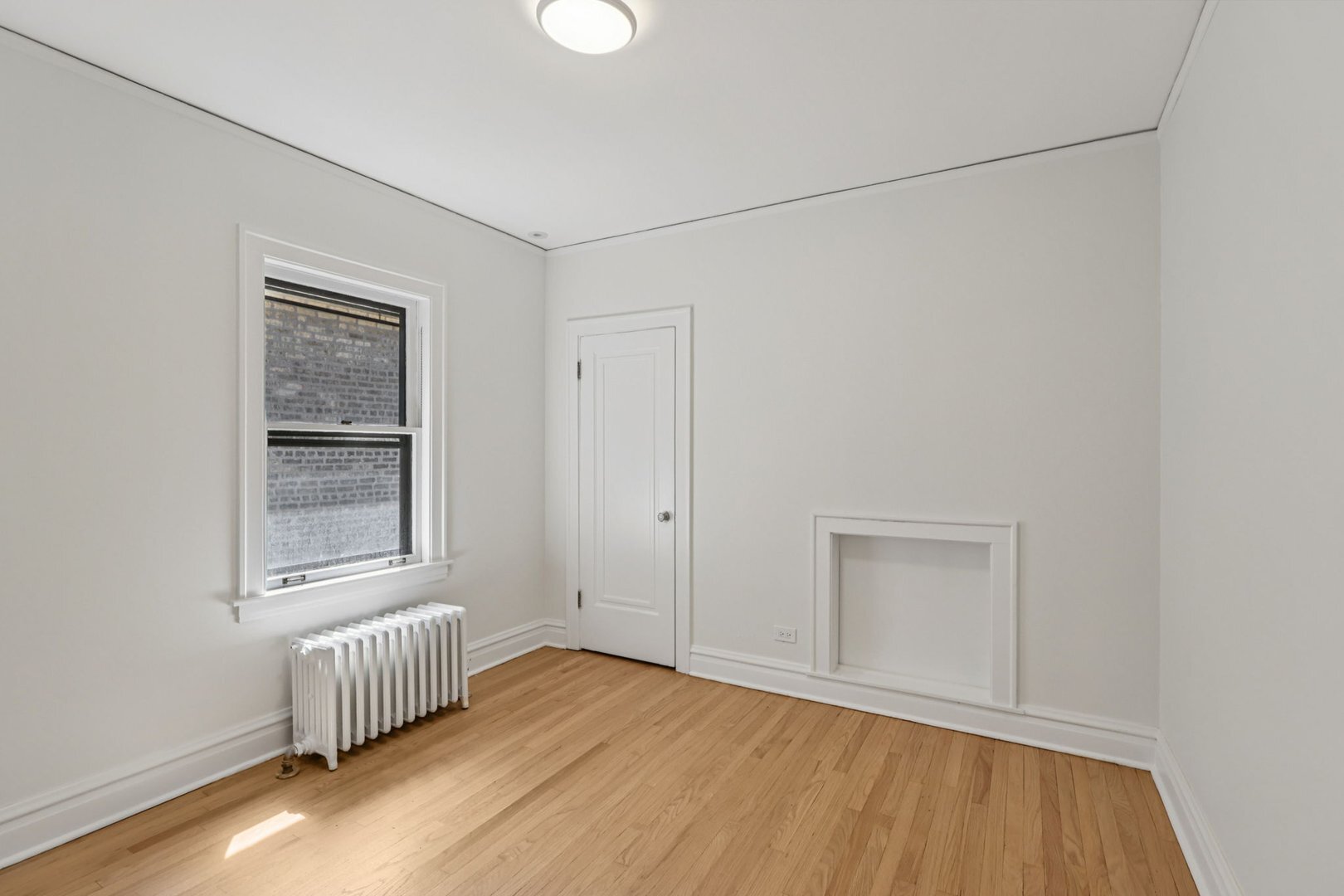 5253 Cleveland Street Skokie, IL 60077 - Photo 21 of 57 an empty room with wooden floor and windows