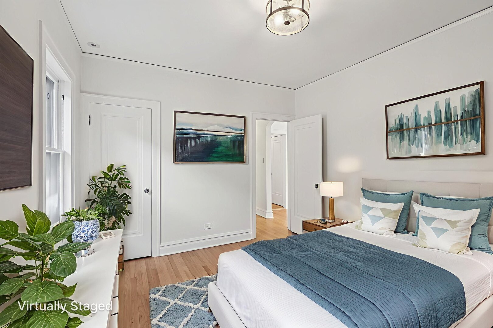 5253 Cleveland Street Skokie, IL 60077 - Photo 25 of 57 a bedroom with a bed and a potted plant