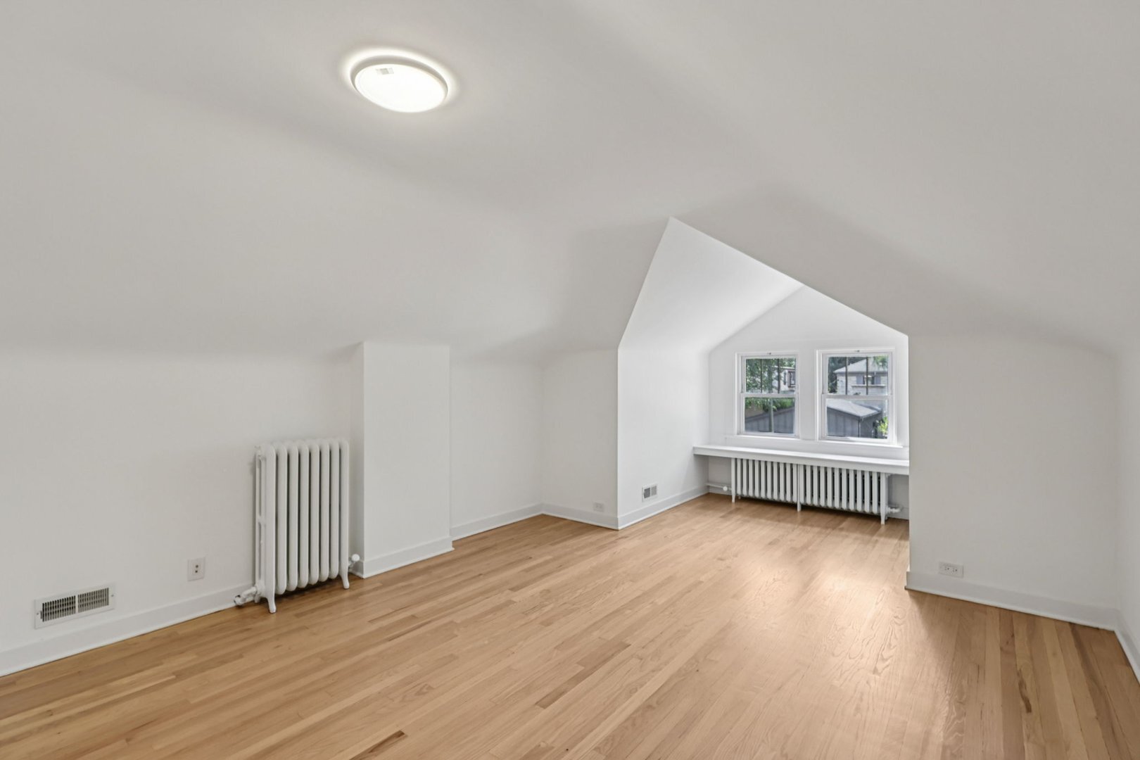 5253 Cleveland Street Skokie, IL 60077 - Photo 29 of 57 an empty room with wooden floor and windows