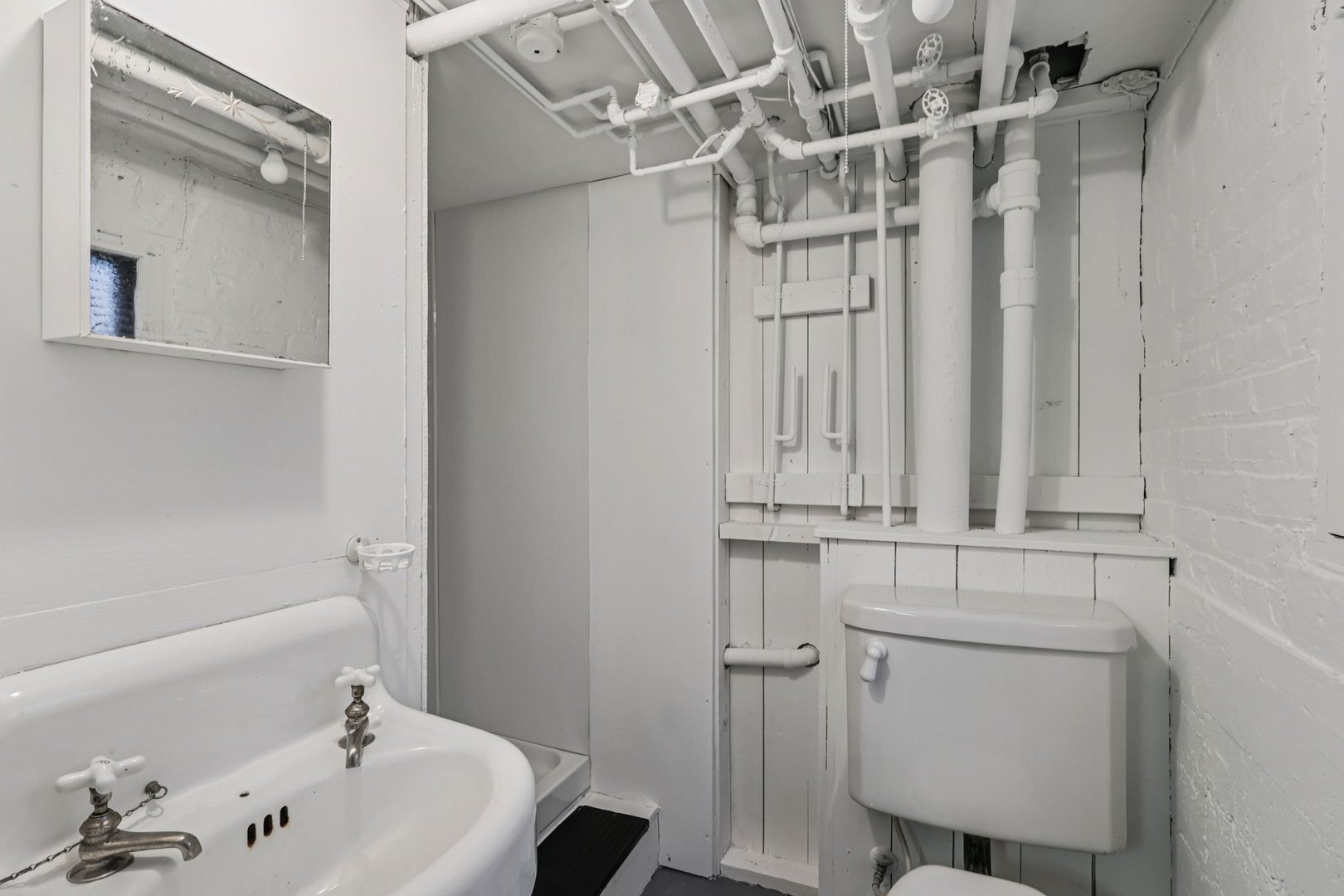 5253 Cleveland Street Skokie, IL 60077 - Photo 40 of 57 a bathroom with a bathtub a sink and a toilet