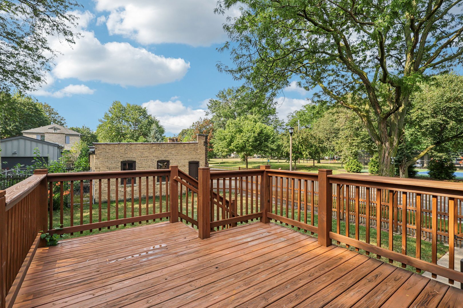 5253 Cleveland Street Skokie, IL 60077 - Photo 45 of 57 a view of deck with wooden floor and fence