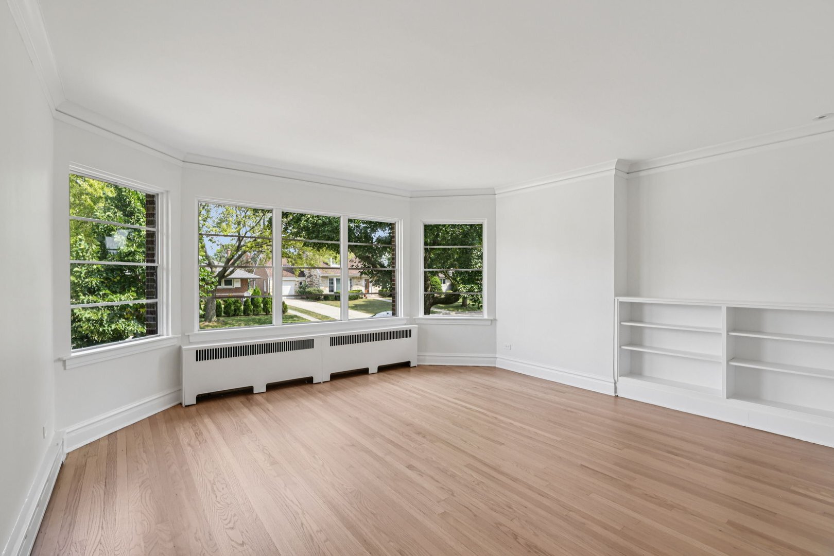5253 Cleveland Street Skokie, IL 60077 - Photo 7 of 57 an empty room with wooden floor and windows