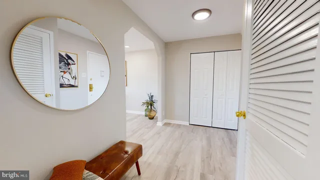 a bed room with a bed and a painting on the wall