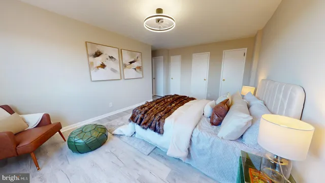 a white bed sitting in a bedroom next to a window