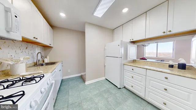 a view of a dining room with furniture a chandelier and wooden floor