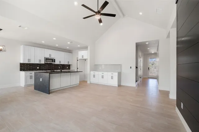 a view of a kitchen with a sink and cabinets