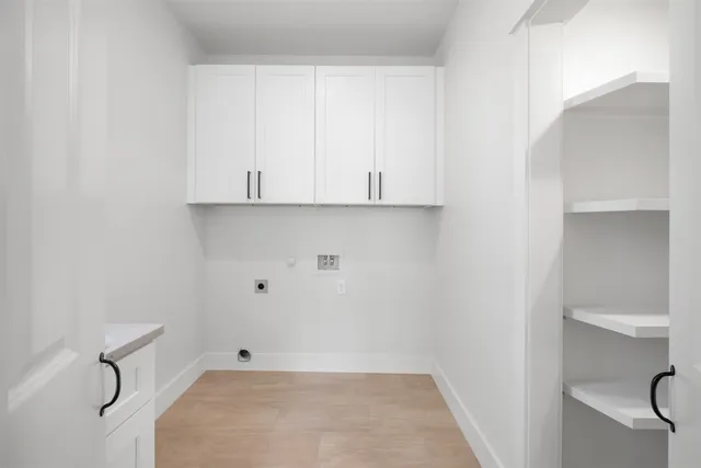 a kitchen with granite countertop a sink and white cabinets