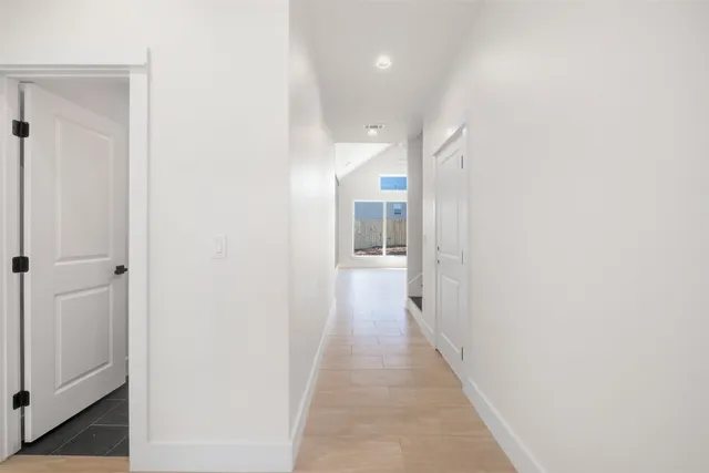 a view of a hallway with a white walls