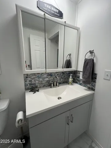 a bathroom with a sink and a mirror