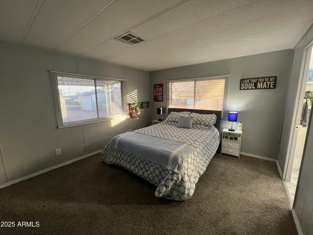 a spacious bedroom with a bed and window