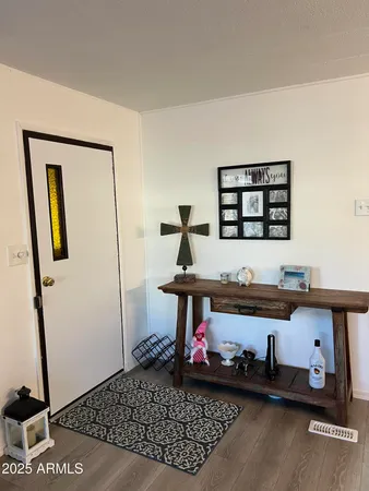 a room with painting on the wall and a rug