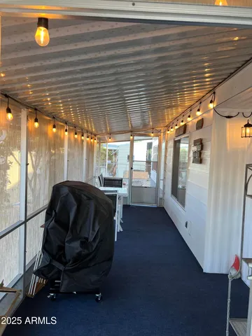 a view of a roof deck with table and chairs a barbeque