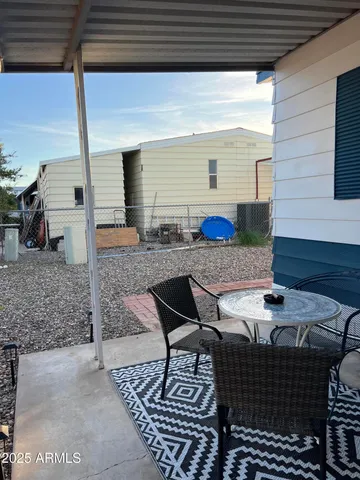 a backyard of a house with table and chairs
