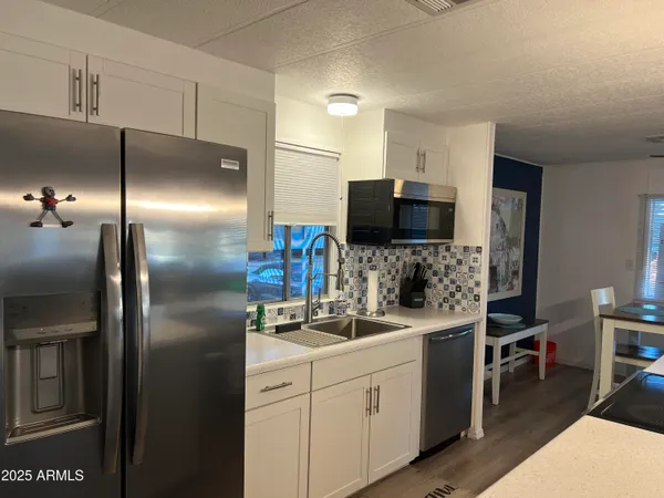 a kitchen with a refrigerator and a sink