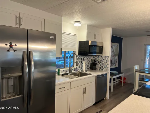 a kitchen with a refrigerator and a sink