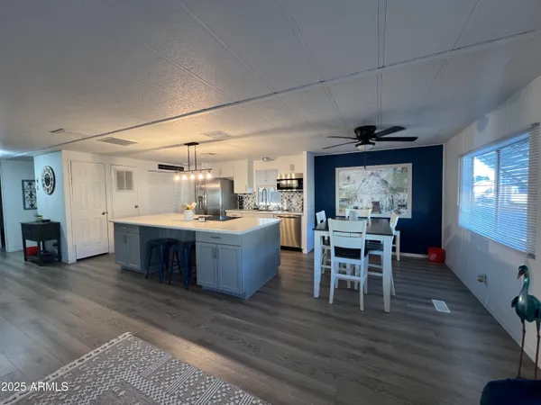 a kitchen with a table chairs and a sink