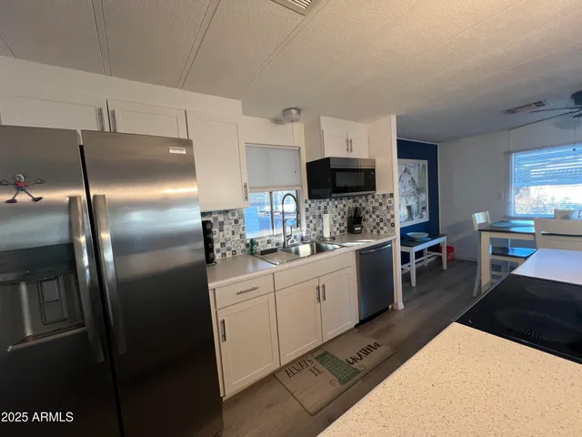 a kitchen with a sink stainless steel appliances and cabinets
