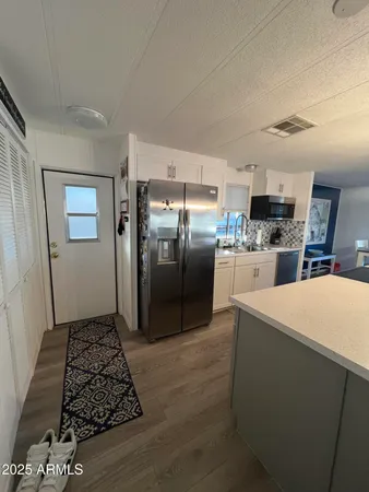 a kitchen with stainless steel appliances granite countertop a refrigerator and a stove