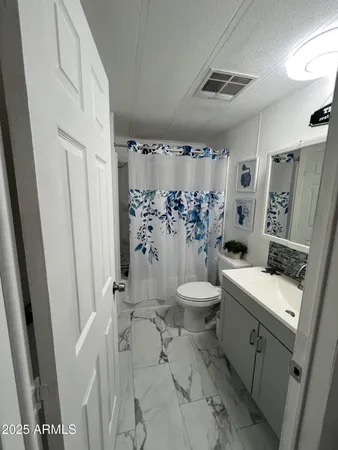 a bathroom with a toilet sink and shower