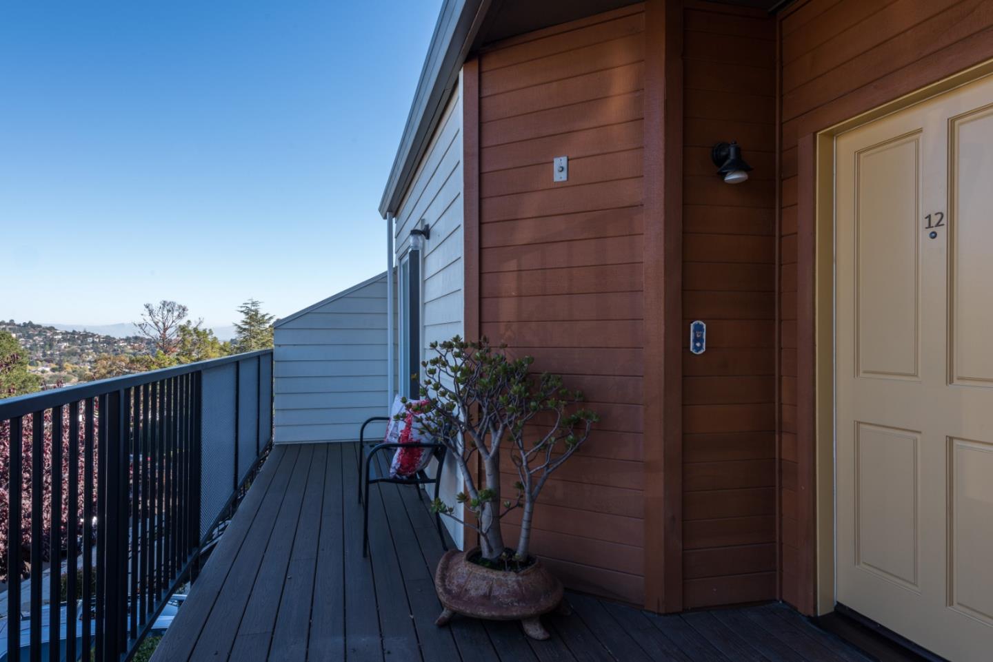 1040 Continentals Way, Unit 12 Belmont, CA 94002 - Photo 2 of 30 a potted plant sitting in front of a door