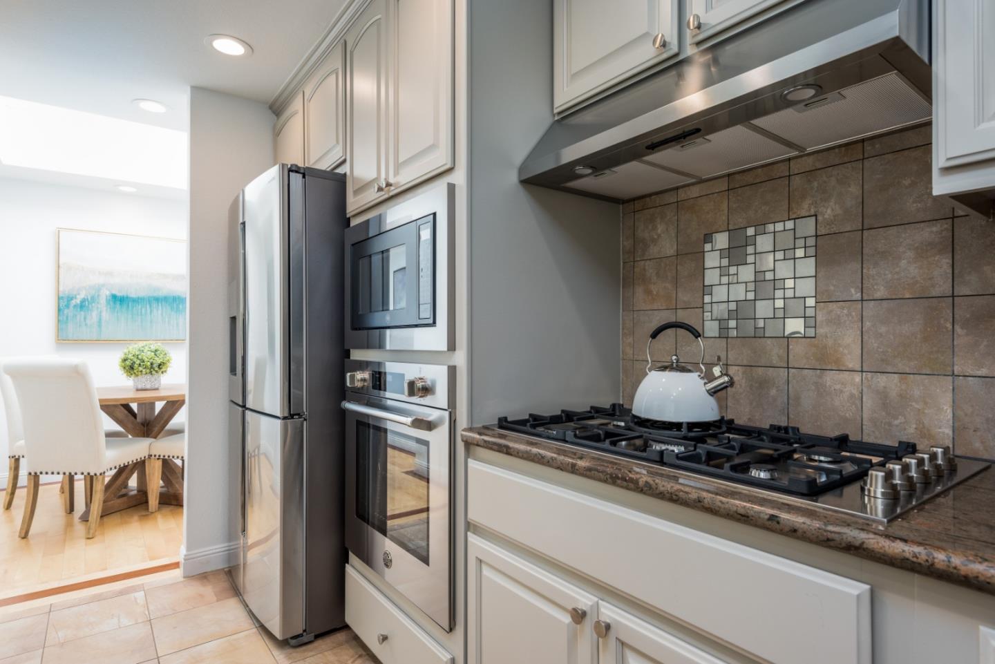 1040 Continentals Way, Unit 12 Belmont, CA 94002 - Photo 11 of 30 a kitchen with a stove and a refrigerator