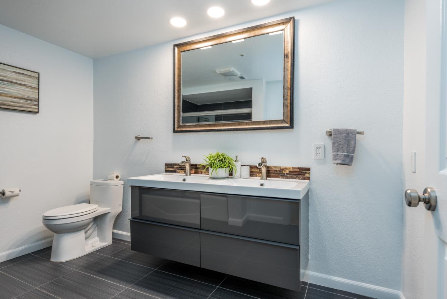 1040 Continentals Way, Unit 12 Belmont, CA 94002 - Photo 21 of 30 a bathroom with a toilet sink and mirror