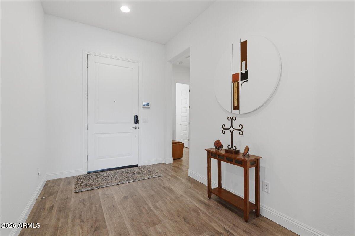 22608 East Stacey Road Queen Creek, AZ 85142 - Photo 6 of 83 a view of a room with wooden floor and white walls