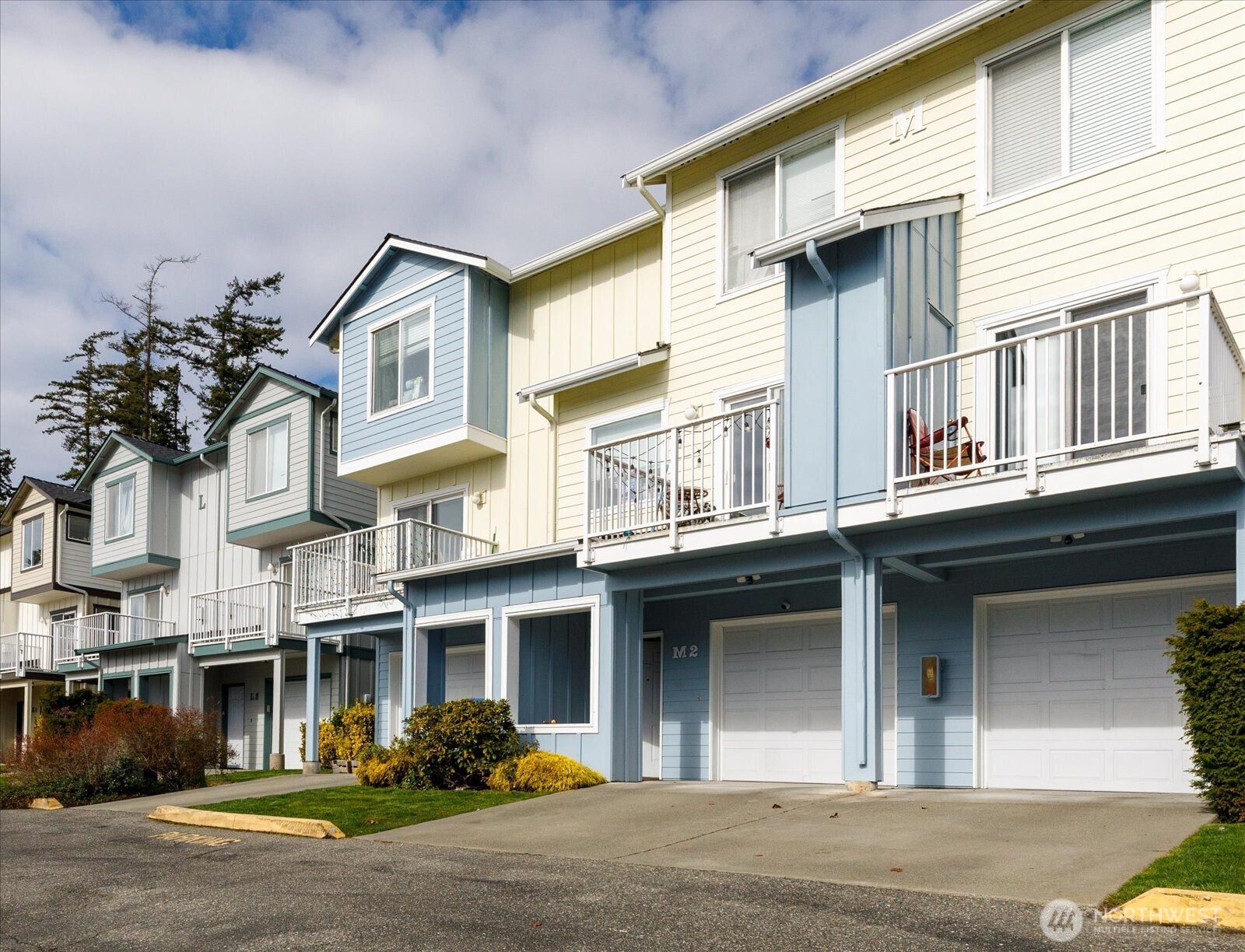 30875 State Rte 20, Unit M2 Oak Harbor, WA 98277 - Photo 1 of 29 a front view of a residential apartment building with a yard