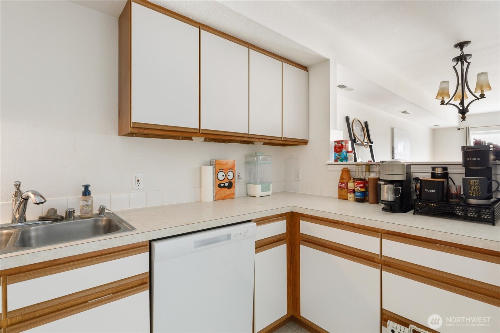 30875 State Rte 20, Unit M2 Oak Harbor, WA 98277 - Photo 11 of 29 a kitchen with stainless steel appliances granite countertop a sink dishwasher and cabinets with wooden floor