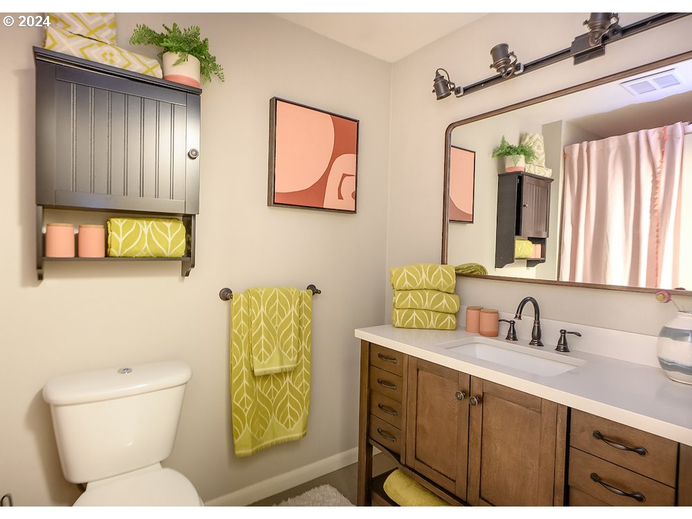 2097 Southwest Brixton Place Gresham, OR 97080 - Photo 20 of 43 a bathroom with a toilet sink and mirror