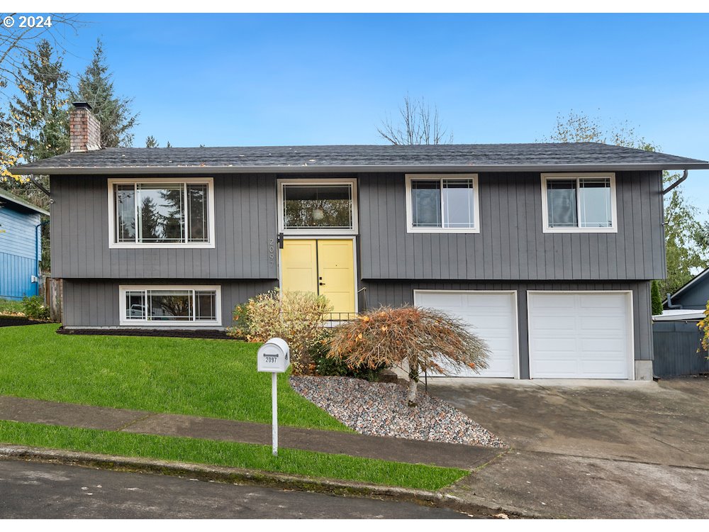 2097 Southwest Brixton Place Gresham, OR 97080 - Photo 2 of 43 a front view of a house with garden