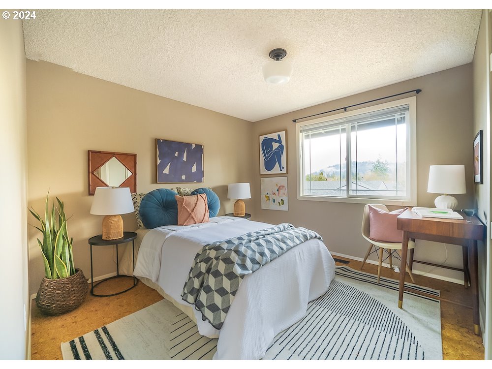 2097 Southwest Brixton Place Gresham, OR 97080 - Photo 21 of 43 a bedroom with a bed and a large window