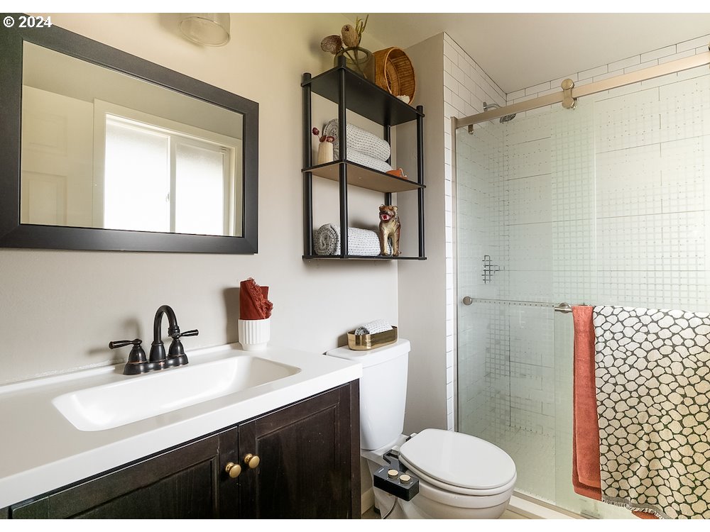 2097 Southwest Brixton Place Gresham, OR 97080 - Photo 28 of 43 a bathroom with a sink a toilet and shower