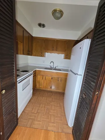 a bathroom with a sink a toilet a mirror and shower