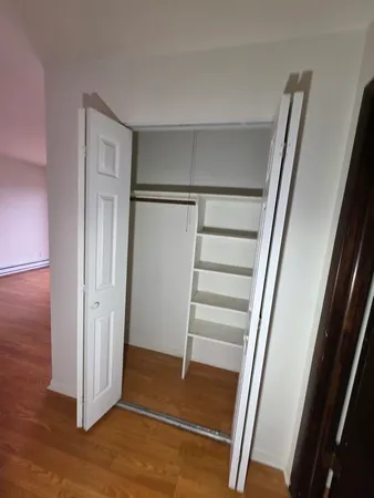 a view of an empty room with glass door